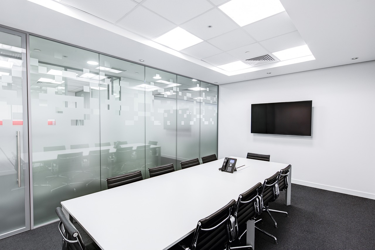  Image of meeting room with glass wall, long table, and chairs.