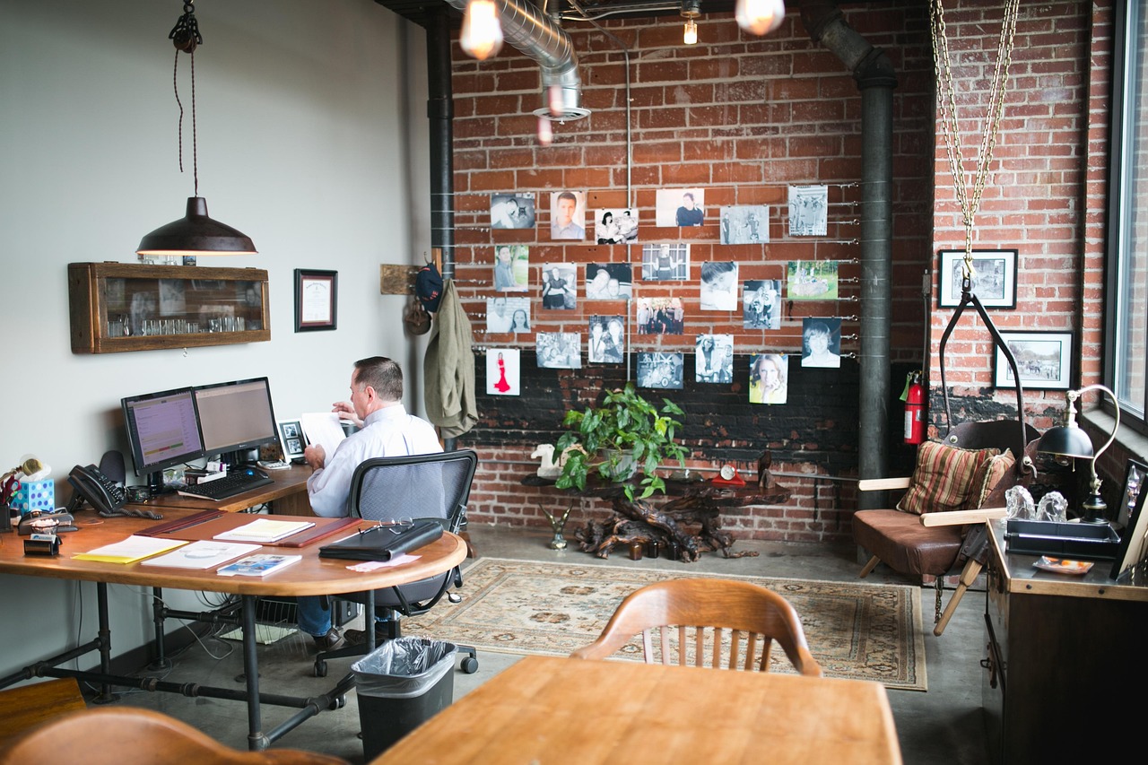  Image of a man sitting at his desk staring at his monitors.